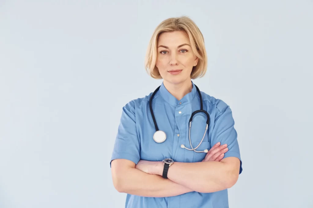 confident doctor stands with stethoscope in light utc